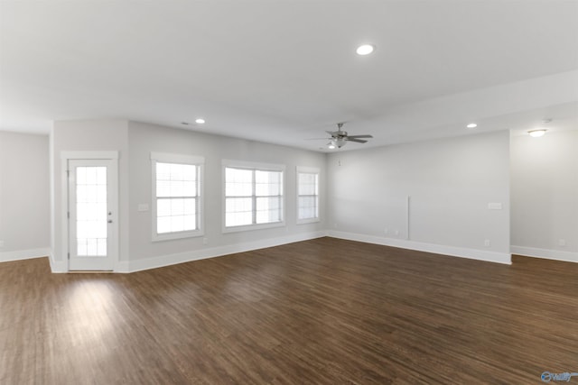 unfurnished living room with baseboards, ceiling fan, dark wood finished floors, and recessed lighting