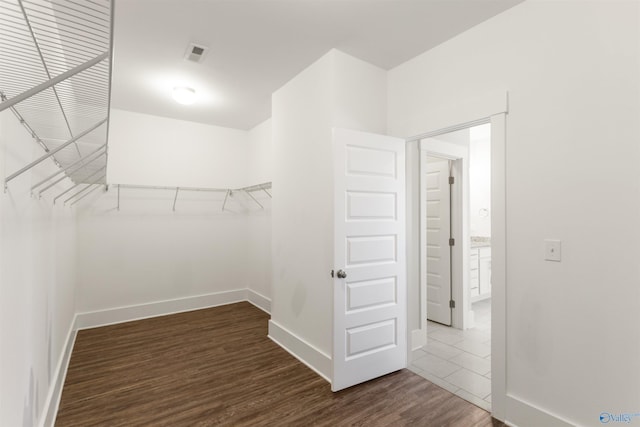 walk in closet featuring dark wood-style floors and visible vents