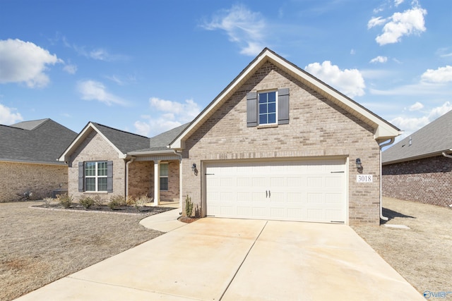 traditional-style home with a garage, brick siding, driveway, and a shingled roof