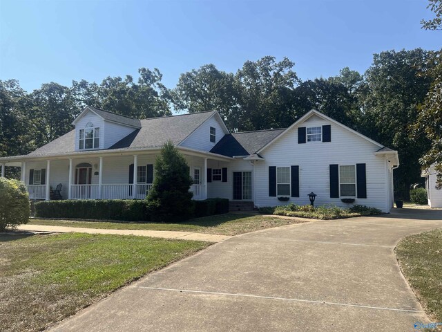 view of front of property with a front yard and a porch