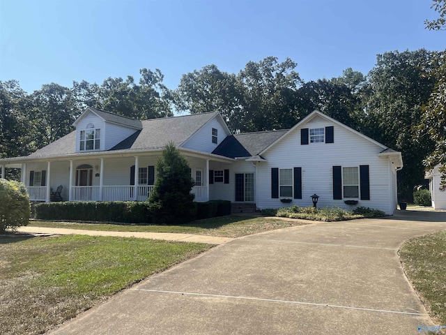 view of front of home with a porch and a front lawn