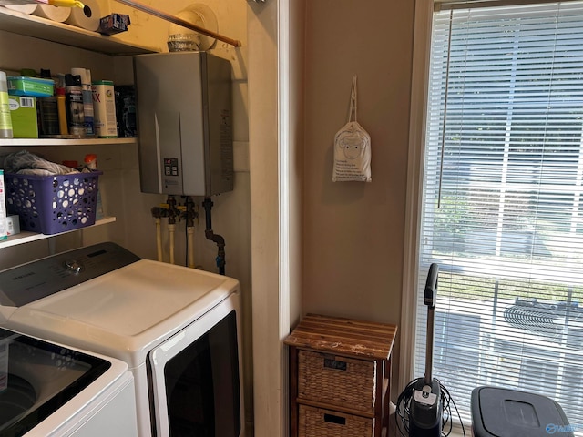 laundry area with independent washer and dryer and water heater