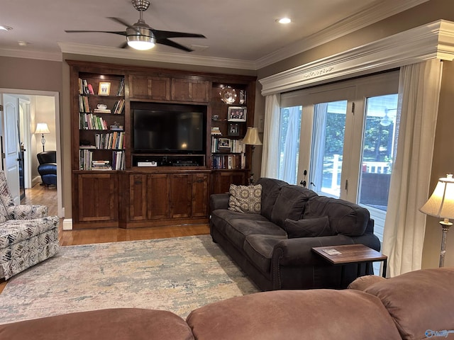 living room with a ceiling fan, light wood-style floors, and ornamental molding