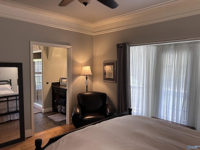 bedroom featuring ceiling fan, wood finished floors, and crown molding