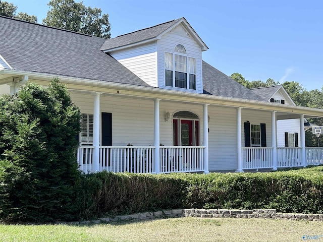 farmhouse with covered porch and a shingled roof