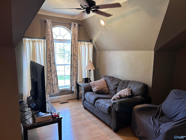 living room with lofted ceiling, ceiling fan, and light hardwood / wood-style floors