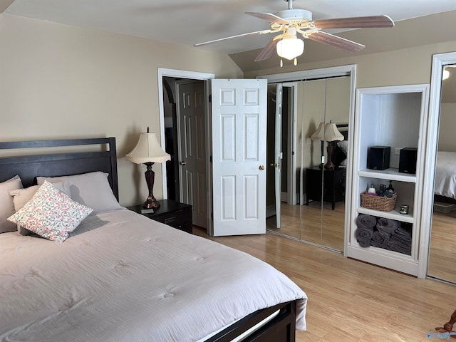 bedroom with light hardwood / wood-style flooring, ceiling fan, and a closet