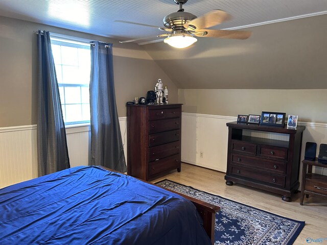 bedroom with light hardwood / wood-style flooring, ceiling fan, and vaulted ceiling