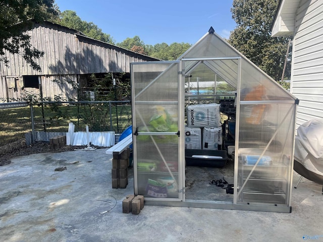 view of greenhouse with fence