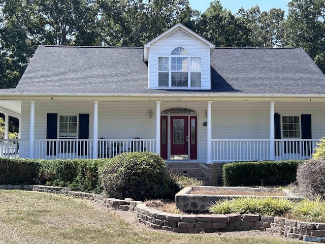 view of front of property with covered porch and a shingled roof