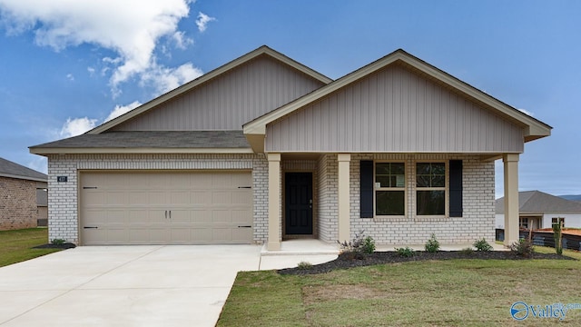 view of front of property with a garage and a front yard