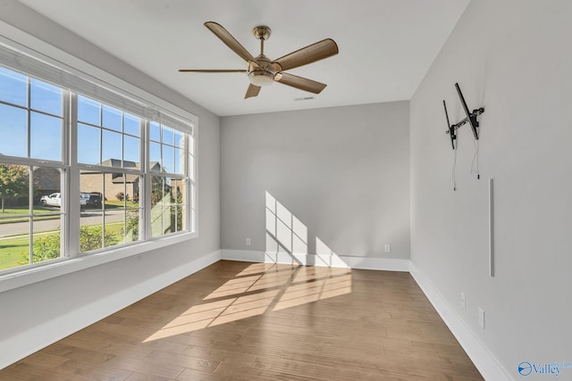 spare room featuring wood-type flooring and ceiling fan