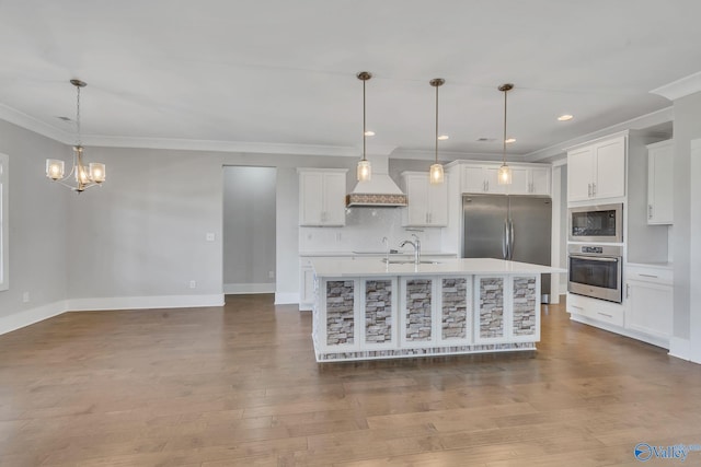 kitchen with white cabinetry, stainless steel appliances, and hanging light fixtures