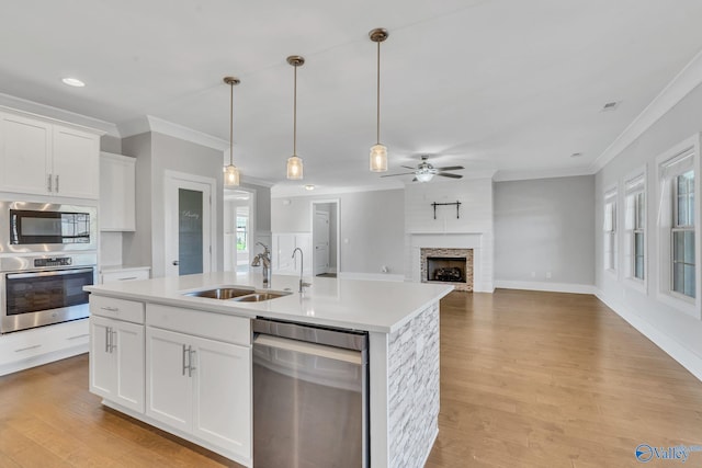 kitchen featuring a wealth of natural light, white cabinetry, and stainless steel appliances