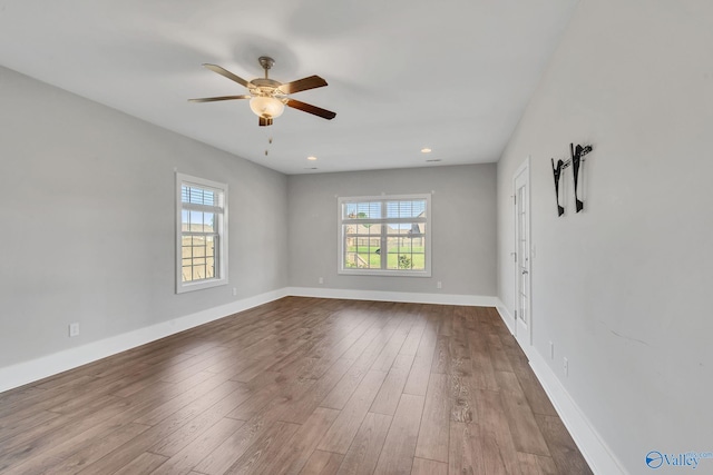 spare room with wood-type flooring and ceiling fan