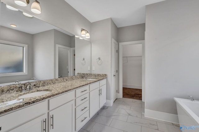 bathroom featuring vanity and a tub to relax in