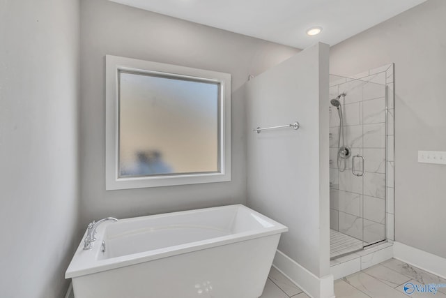 bathroom with separate shower and tub