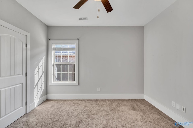 spare room with light colored carpet and ceiling fan