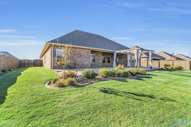 rear view of house featuring a patio area and a lawn