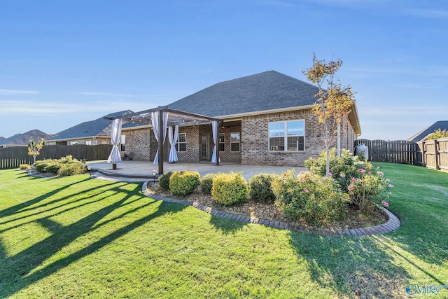 rear view of property featuring a yard and a patio area