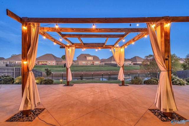 patio terrace at dusk featuring a pergola