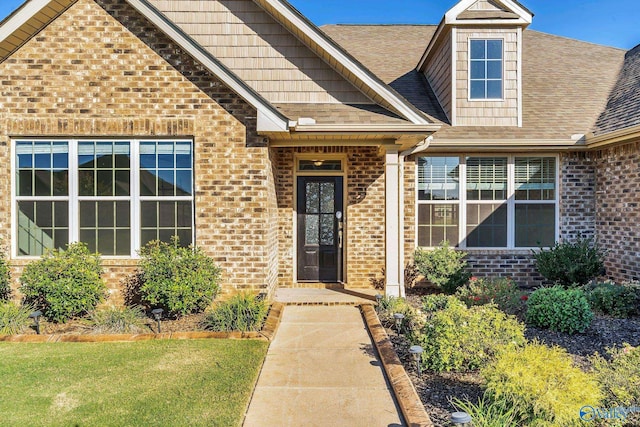 entrance to property featuring a yard