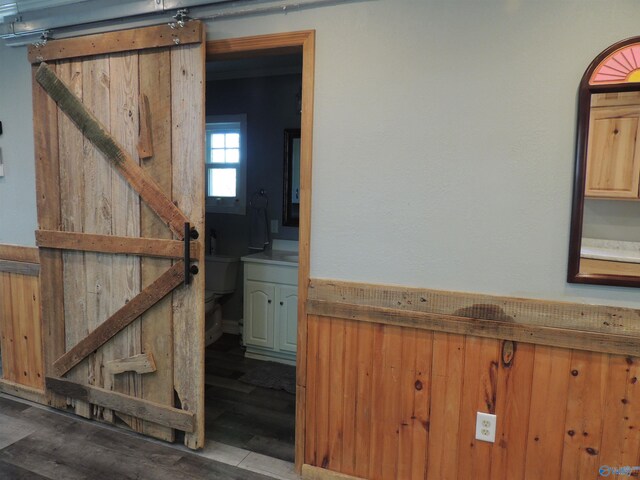 interior space featuring a barn door and wood finished floors
