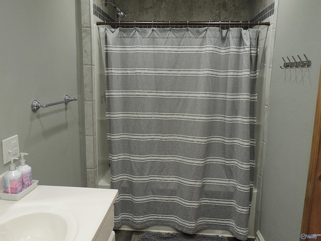 full bath with a shower with curtain and vanity