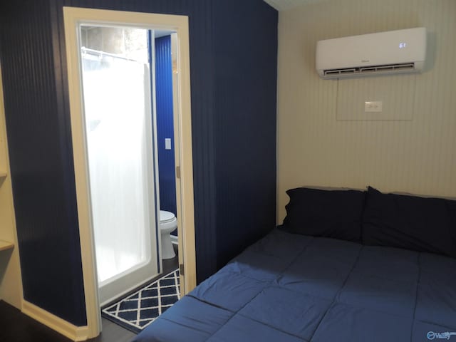 bedroom featuring an AC wall unit