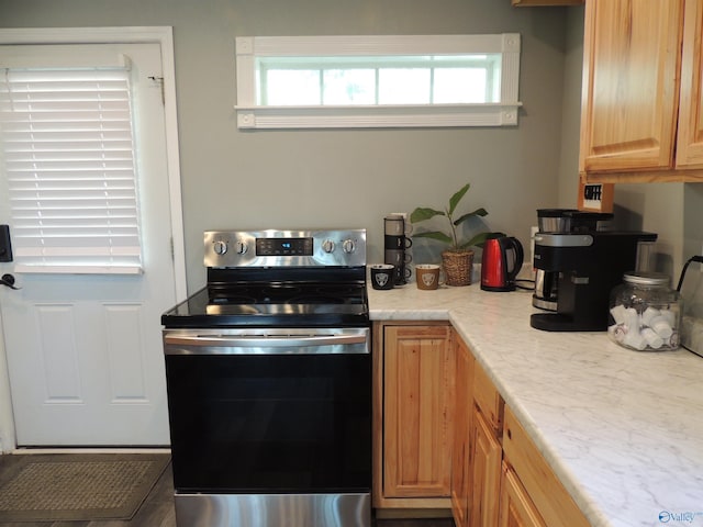 kitchen with a wealth of natural light and stainless steel range with electric stovetop