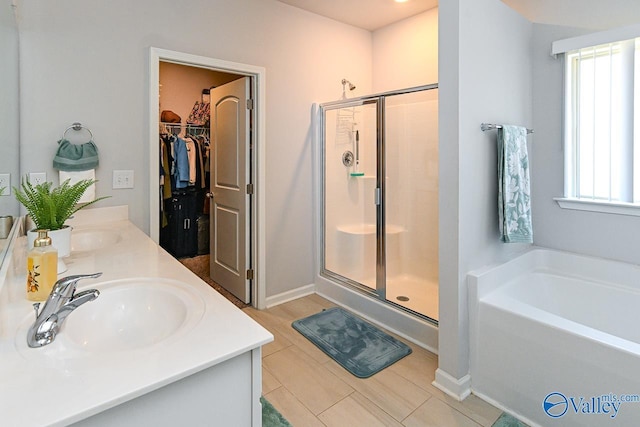 bathroom with vanity, a healthy amount of sunlight, and shower with separate bathtub