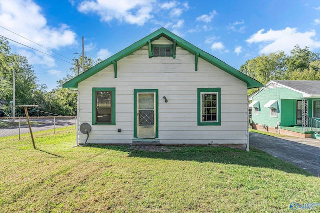 rear view of house with a lawn