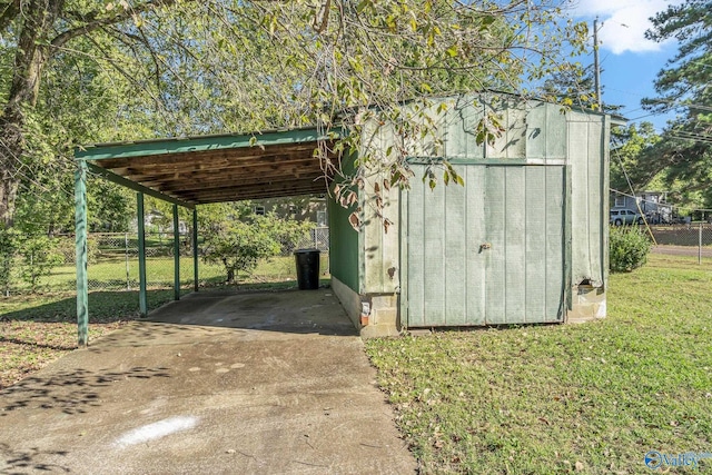 1011 Hermosa Ave, Gadsden, AL 35901 - view of shed with fence, driveway, and an attached carport
