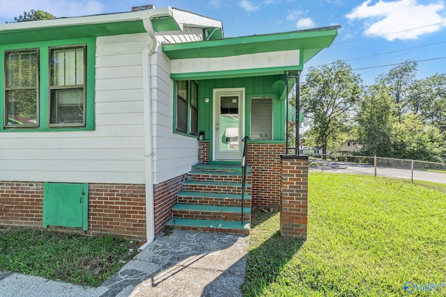 property entrance with a yard