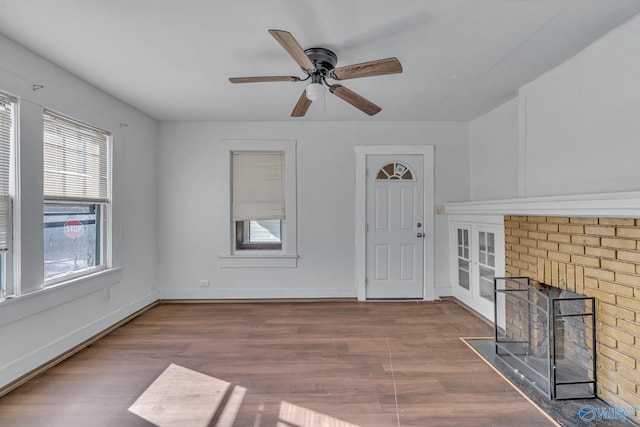 1011 Hermosa Ave, Gadsden, AL 35901 - unfurnished living room with wood finished floors, a ceiling fan, and a fireplace