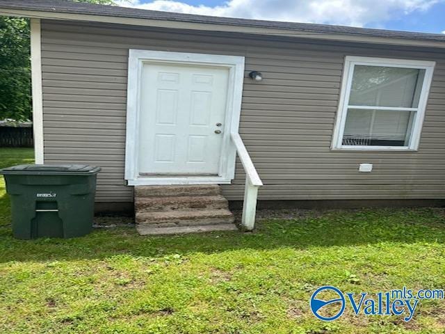 property entrance with a yard