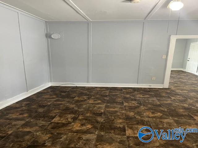 unfurnished room with a decorative wall