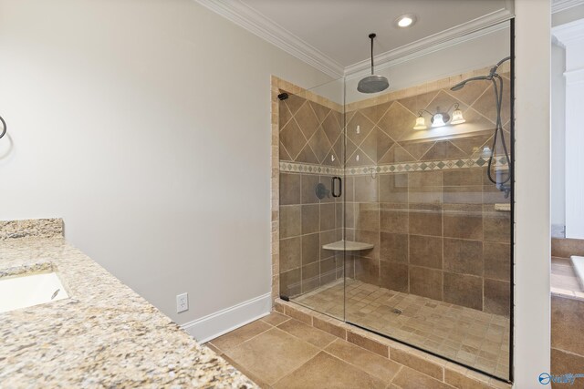 full bathroom featuring crown molding, a shower stall, vanity, baseboards, and tile patterned floors