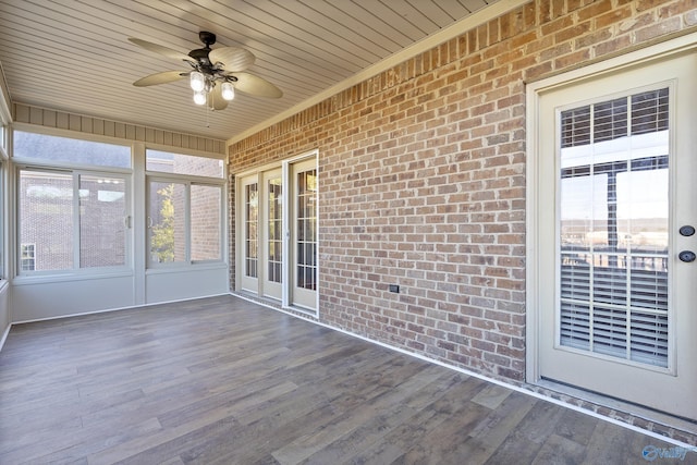 unfurnished sunroom with wooden ceiling and ceiling fan