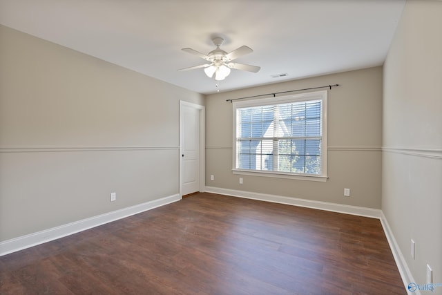 spare room with ceiling fan, baseboards, and wood finished floors