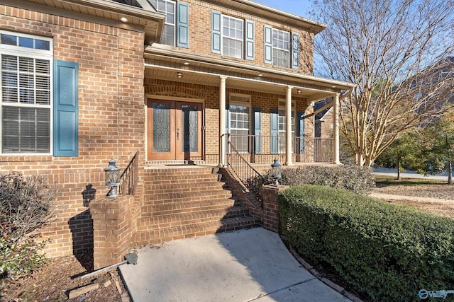 property entrance featuring a porch and brick siding