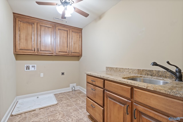 washroom featuring cabinet space, baseboards, a sink, hookup for a washing machine, and electric dryer hookup