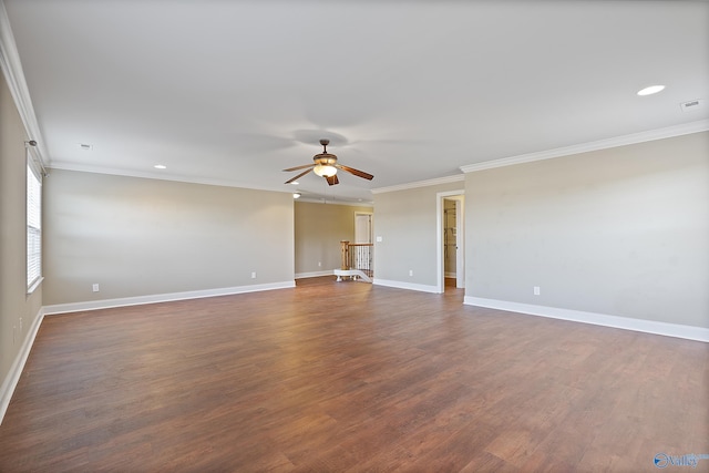 empty room with ceiling fan, baseboards, dark wood finished floors, and crown molding