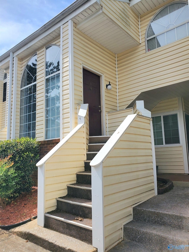 view of exterior entry with brick siding