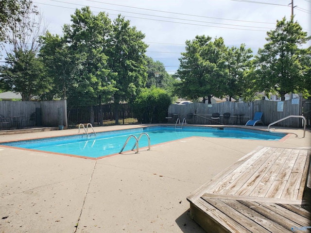 view of pool with a patio area, a fenced in pool, and fence