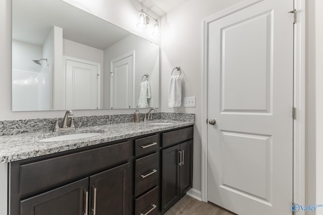 bathroom with vanity and hardwood / wood-style flooring