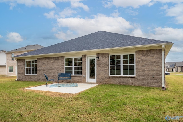 rear view of property with a lawn and a patio area