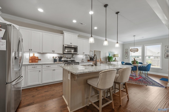 kitchen with white cabinetry, crown molding, a sink, visible vents, and stainless steel appliances