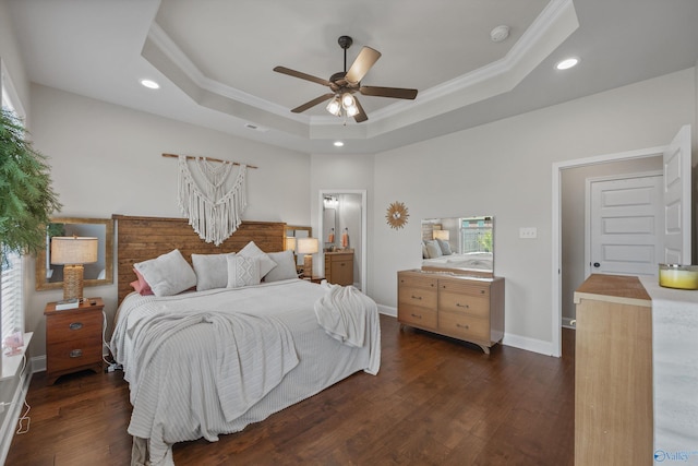 bedroom featuring ornamental molding, recessed lighting, dark wood-style floors, and a tray ceiling