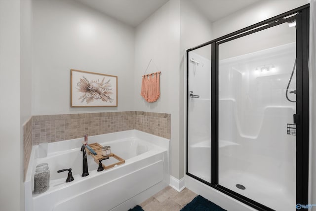 bathroom featuring a shower stall, a bath, and tile patterned flooring